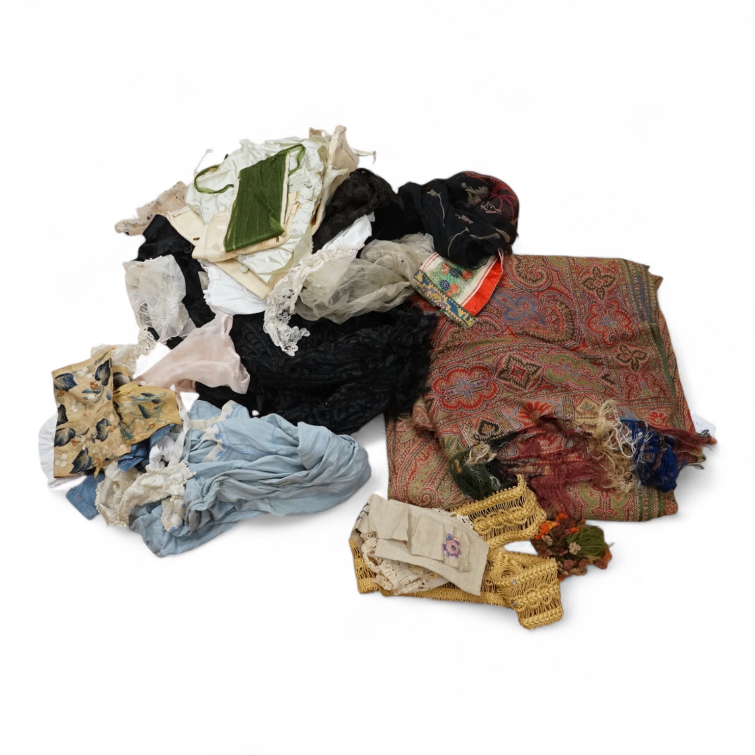 A collection of 19th century fabric and clothing, including a woven Paisley shawl, good for film and TV costume dramas